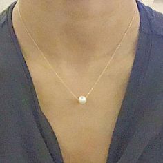 A beautiful, dainty floating pearl necklace made of 9ct yellow gold. The pearl is a genuine cultured freshwater pearl. It is 8mm in diameter and has been hand drilled to float on a 0.75mm delicate 9ct gold chain. Chain length can be chosen from the drop box at checkout. Pearl is the birthstone for June and so this stunning necklace would make the perfect gift for a June baby. Pearl also represents the 30th anniversary of a special bond and can be given as an anniversary present to signify the be Minimalist 14k Gold Pearl Pendant Necklace, Minimalist 14k Gold Pearl Necklace, Minimalist 14k Gold Pearl Necklace With Pearl Charm, Minimalist Yellow Gold Pearl Necklace For Anniversary, Minimalist Yellow Gold Pearl Necklace, Minimalist 14k Gold Pearl Necklace Gift, Minimalist 14k Gold Necklace With Pearl Pendant, Minimalist Yellow Gold Charm Necklace With Pearl Chain, White Pearl Necklace With Delicate 14k Gold Chain