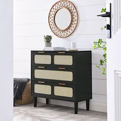 a black and white dresser in a room with a mirror on the wall above it