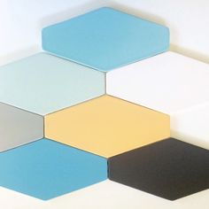 several different colored hexagonal tiles are arranged in the shape of hexagons