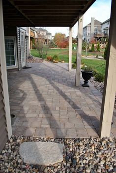 a walkway with rocks and gravel between two buildings