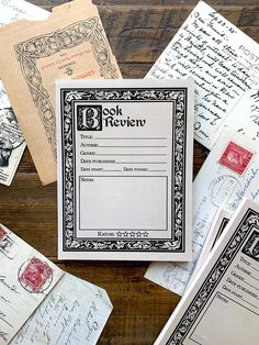 several old envelopes and letters on a wooden table