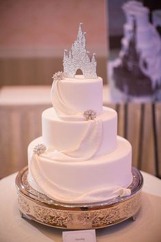 a white wedding cake with a castle on top