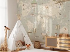 a child's room with a teepee tent, giraffe and map wallpaper