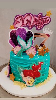 a birthday cake with ariel the mermaid on top