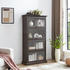 a living room with a couch, chair and bookcase in it's corner