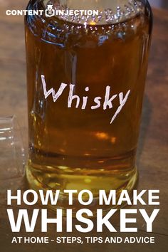 a bottle of whiskey sitting on top of a wooden table