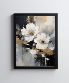 an abstract painting with white flowers in black and gold frame on the wall above it