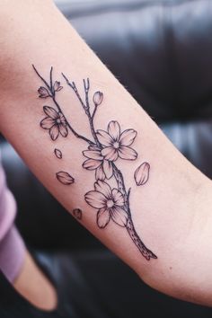 a woman's arm with flowers on it