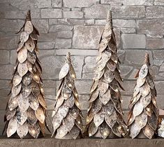 three wooden christmas trees with lights on them