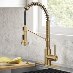 a kitchen faucet with an apple on the counter