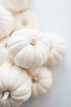 small white pumpkins sitting on top of each other