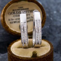 These attractive diamond hoop earrings are each accented with two-rows of ten (10) channel set round brilliant cut diamonds. The earrings measure 27.7mm X 5.0mm and are finished with locking posts for pierced ears. Brand Presentation, Channel Set, Diamond Drop Earrings, Diamond Hoop Earrings, Diamond Drops, Round Brilliant Cut Diamond, Diamond Earrings Studs, Brilliant Cut Diamond, Diamond Studs