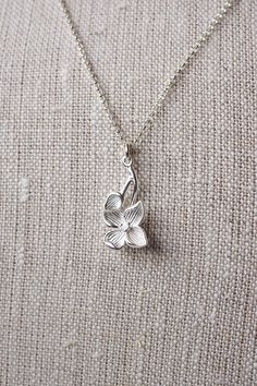 Sterling Silver Dogwood Flower Necklace, No. BSRC023 :*About This Piece*: ♦︎ An elegant recreation of one of spring's loveliest blossoming trees, this sterling silver dogwood blossom pendant is hung on sterling silver rolo chain. The flowering pendant is gorgeous, solid sterling silver. ♦︎ Length - 18 in (45.7 cm) chain ♦︎ Pendant - .47 in (12 mm) x .9 in (23 mm) ♦︎ All items from my shop are packaged in padded cardboard jewelry boxes. Custom gifting options available upon request. ♦︎ Are you lo Blossom Color Sterling Silver Flower Jewelry, Blossom Colored Flower-shaped Sterling Silver Jewelry, Delicate Sterling Silver Jewelry For Spring, Spring Delicate Sterling Silver Jewelry, Spring Wedding Sterling Silver Jewelry, Spring Sterling Silver Jewelry With Flower Charm, Silver Necklaces For Spring Gift, Silver Necklace For Spring Gift, Spring Gift Silver Necklace