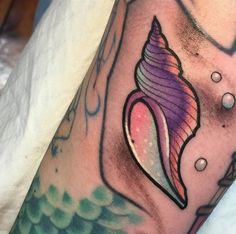 a colorful tattoo with a seashell on it