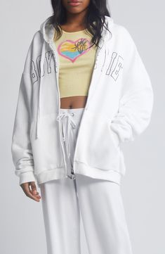 A roomy hoodie features a beachy image and the brand's signature spelled out on the front. 27" length (size M/L) Front zip closure Drawstring hood Split kangaroo pocket 99% rayon, 1% spandex Machine wash, tumble dry Imported White Graphic Print Hoodie For Loungewear, White Sporty Hoodie For Leisure, Sporty White Hoodie For Leisure, White Athleisure Hoodie With Drawstring, White Drawstring Hood Sweatshirt For Leisure, Trendy White Hoodie For Loungewear, White Hoodie With Drawstring For Streetwear, White Drawstring Hoodie For Streetwear, White Cotton Hoodie For Leisure