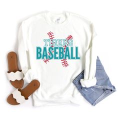 "Baseball Sweatshirt, Baseball Mom Shirt, Custom Baseball Shirts for Women, Personalized Baseball Sweater, Baseball Team Tees, Baseball Gift This custom baseball sweatshirt is so soft, comfy & stylish and perfect to keep you warm and cozy for baseball game day! HOW TO ORDER:  Please leave the team\\mascot name, and the font & font outline colors you would like in the \"Add your personalization\" text box. Please message me if you have any questions before ordering. This UNISEX sweatshirt will last for years. Good quality material that needs no ironing. All inks used to print are high quality, water-based and eco-friendly. 50/50 cotton/polyester 8.0 oz. fabric weight Reduced pilling and softer air-jet spun yarn All products are made-to-order. Colors may vary slightly from one computer/phone College Baseball Season Crew Neck Shirt, Varsity Screen Print Tops For Sports Season, Varsity Style Screen Print Tops For Sports Season, White Long Sleeve School Spirit Shirt, White Long Sleeve Shirt For School Spirit, College Baseball Season Screen Print Tops, Long Sleeve Tops For Baseball Season, Varsity Sports Top With Lettering, Sports Fan Apparel Tops With Lettering