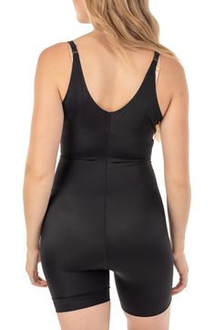 Designed to slim you in all the right places. Targeted fused front panel keeps your stomach looking toned. High spandex content smooths and slims your hips and thighs. 24 1/2" length; 8" rise (size Small-Medium) Scoop neck 85% nylon, 15% spandex Machine wash, dry flat Imported Model stats: 5'10" height, 32" bust, 25" waist, 36" hip. Model is wearing size Small-Medium. Fitted Nylon Tankini With Built-in Padding, Sleek Fitted Swimwear With Built-in Bra, Fitted Sports Shapewear With Built-in Bra, Fitted Shapewear With Built-in Padding For Workout, Swimwear For Swimming, Fitted Elastane Shapewear For Yoga, Fitted Workout Tankini With Built-in Bra, Black Fitted Shapewear Unitard, High Stretch Swimwear With Medium Bust Support