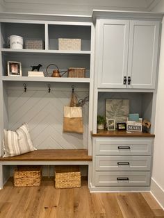 a white closet with shelves, drawers and baskets