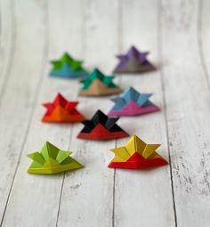 colorful origami stars arranged on white wood