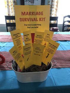 a bucket filled with lots of yellow sticky notes sitting on top of a blue table cloth