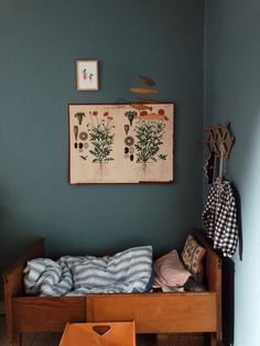 a wooden bed sitting under a painting on the wall