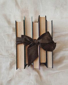 an open book with a bow on it