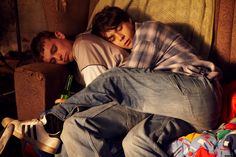 two men sleeping on couches with beer bottles