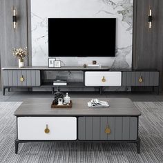 a living room with grey and white furniture in front of a flat screen tv on the wall