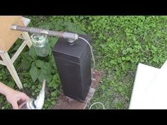 a person is using scissors to cut something off the ground next to a trash can