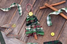 a christmas tree made out of fabric and buttons on a wooden table with other items