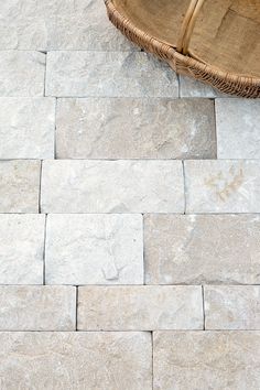 a basket sitting on top of a stone floor