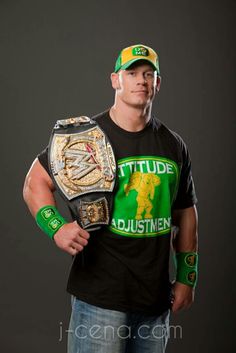 a man wearing a hat and holding a wrestling belt