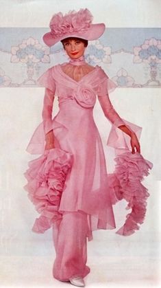 a woman in a pink dress and hat with ruffles on the skirt is posing for