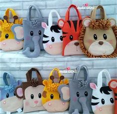 several purses made to look like animals on display in front of a brick wall