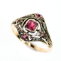 This Art Deco Inspired ring has been beautifully crafted in 9ct solid gold with impeccable craftmanship.Take a closer look at the openwork design that captures the eye of the beholder and onlooker alike with many unexpected details. Gorgeous shoulder patterns, crown patterns and pretty fleur de lis patterns which have been claw set with Pink Tourmalines are the highlight of this woman's art deco ring.  8 Genuine Earth Mined Natural Diamonds have been set in a pair on each corner of the face addi Victorian 14k Gold Ruby Ring With Intricate Design, Victorian Yellow Gold Rings With Accent Stones, Antique 14k Gold Ruby Ring With Birthstone, Victorian Hallmarked Rose Gold Ruby Ring, Victorian Rose Gold Ruby Ring Hallmarked, Victorian 14k Gold Ruby Ring Gift, Victorian Style 14k Gold Ruby Ring Gift, Antique Rose Gold Ruby Ring In 14k Gold, Antique 14k Rose Gold Ruby Ring