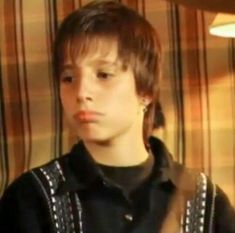 a young boy wearing a black shirt and some lights