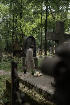 a person standing in front of a grave