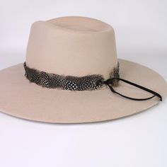 Natural feather hat band. Adjustable with a leather tie. Natural colored feathers Adjustable hatband Approx. 1 inch wide *This product is for 1 single hat band. Hat not included. Adjustable Flat Brim Felt Hat, Adjustable Casual Felt Hat With Flat Crown, Adjustable Fedora For Country Events, Adjustable Leather Fedora For Winter, Adjustable Leather Hat For Fall, Adjustable Flat Crown Top Hat For Fall, Adjustable Leather Winter Fedora, Adjustable Leather Fall Hats, Adjustable Top Hat For Country Events In Fall