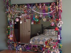 a bed room with a large mirror and lots of beads