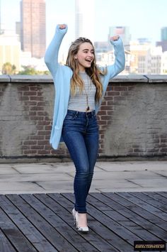 the girl is posing with her arms in the air