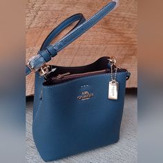 Brand New In Flawless Condition, Gorgeous Midnight Blue Leather, Gold Hardware. Strap Adjusts To Approx 31". Center Zip Compartment, Two Bilateral Snap Closure Compartments. Bag Measures Approx 6.5"H X 6"W. Plum Burgundy Merlot Colored Lining. Elegant Blue Bucket Bag With Gold-tone Hardware, Chic Blue Bucket Bag With Gold-tone Hardware, Blue Coach Bag With Zipper Closure, Blue Coach Bags With Zipper Closure, Blue Coach Shoulder Bag With Gold-tone Hardware, Coach Blue Shoulder Bag With Gold-tone Hardware, Formal Blue Bucket Bag With Adjustable Strap, Blue Formal Bucket Bag With Detachable Strap, Blue Formal Bucket Bag