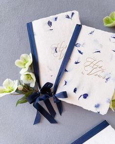 two blue and white napkins with flowers on the side next to eachother