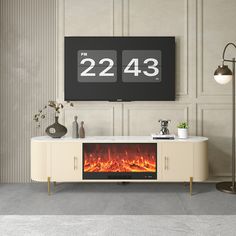 a tv stand with a fireplace in front of it and two large numbers on the wall