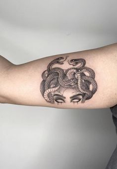 a woman with a snake tattoo on her arm