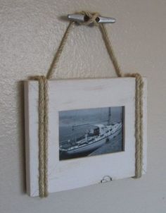 an old photo hanging on the wall with rope