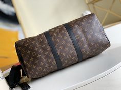 Description   L.V Keepall Bandouliere 45 Monogram Macassar Canvas For Men, Bags, Travel Bags 17.7in/45cm LV M56711   Rep 1:1     This ever popular iconic L.V design is ideal for the busy style-conscious man. Its roomy size and adjustable shoulder strap are perfect features for work, leisure or travel.     45 x 27 x 20 cm / 17.7 x 10.6 x 7.9 inches (Length x height x width)   Monogram Macassar coated Canvas  Natural trimmings  Cotton Textile Lining  Good capacity  Cabin size  Removable name tag  Silver color metal pieces  Strap: Removable, adjustable  Handle: Double   –  Includes dust bag.  –  This product is of the best quality. Perfect Features, Baby Tote Bag, Conscious Man, Louis Vuitton Keepall, Stylish Handbags, Cotton Textile, Luxury Products, Bottega Veneta Shoulder Bag, Evening Clutch Bag