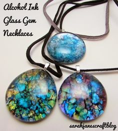 three necklaces with different colors and designs on them, one has a glass bead