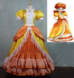 an orange and yellow dress with ruffles on the skirt is next to a mannequin