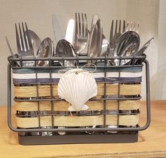 a basket filled with silverware on top of a wooden table next to a knife and fork holder