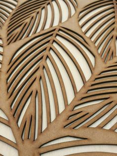 an intricately designed wooden panel with leaves on it